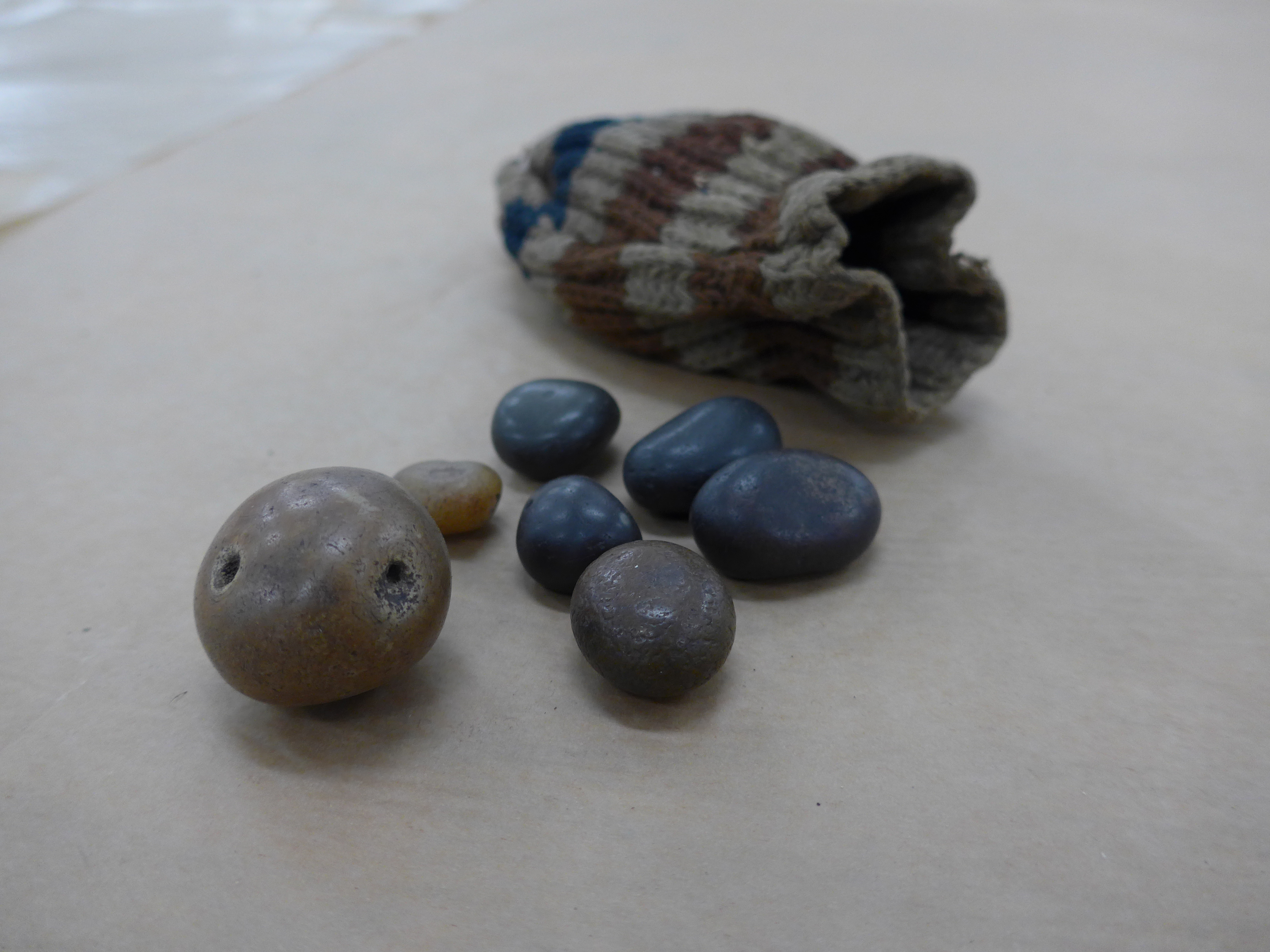 Image: Seven raven stones in a pouch. 